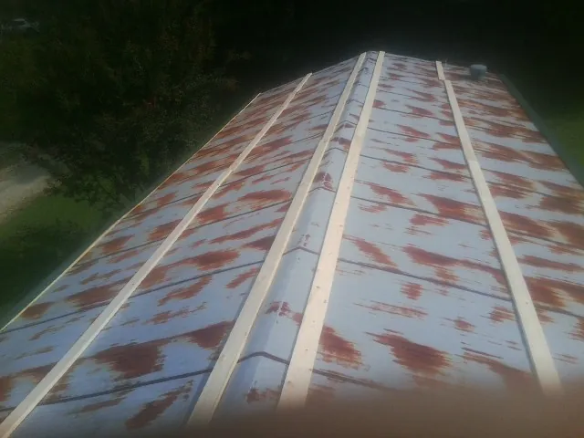 Rusted metal roof panels with new wood purlins before replacement — Storm Damage Roof Repair in Turkey by Roofing Brothers