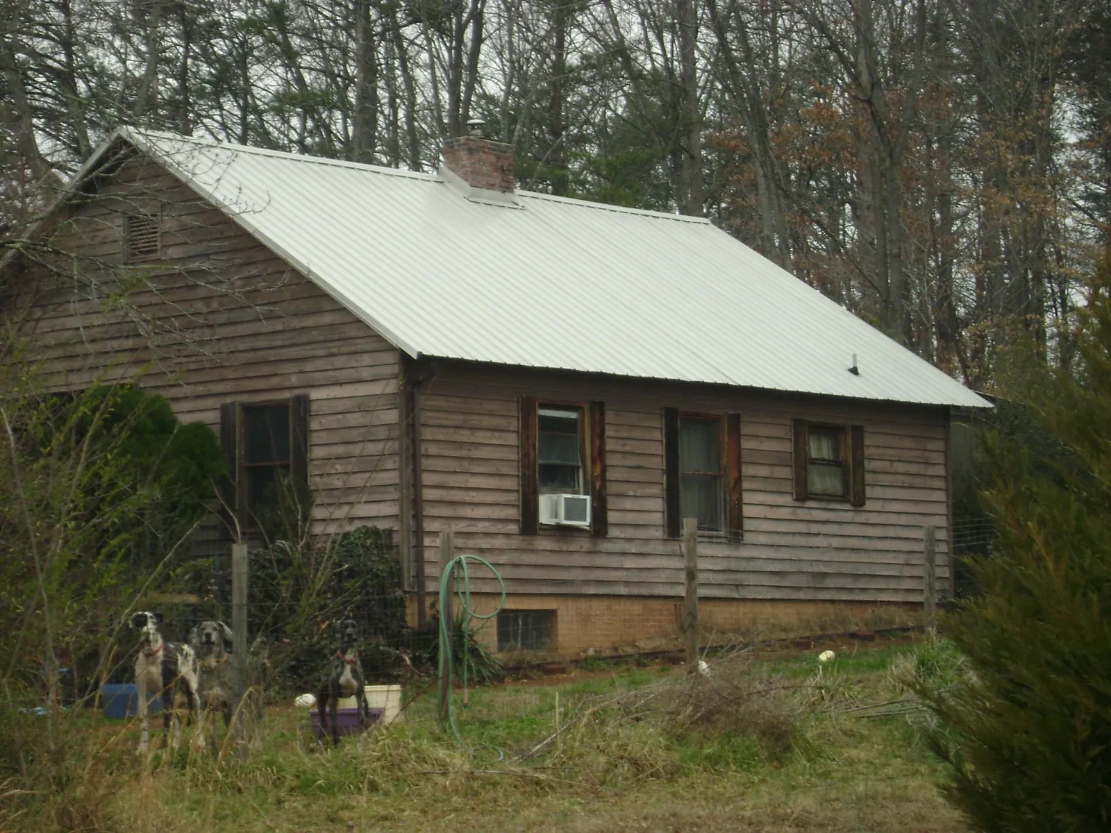 White metal roof on an old wood sided farmhouse, from a Metal Roof Installation job in Turkey